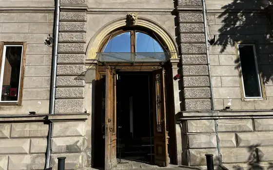 Arched entrance and historic façade of Cărturești Verona in Bucharest.