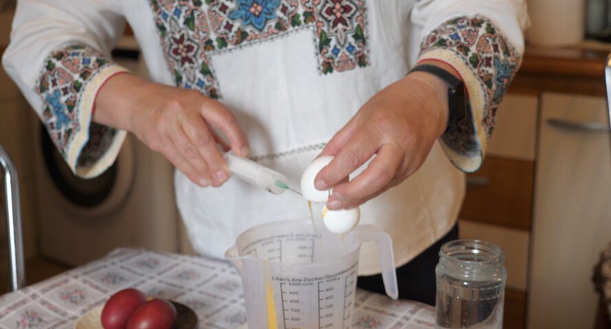 Artisan accidentally cracking egg into measuring cup