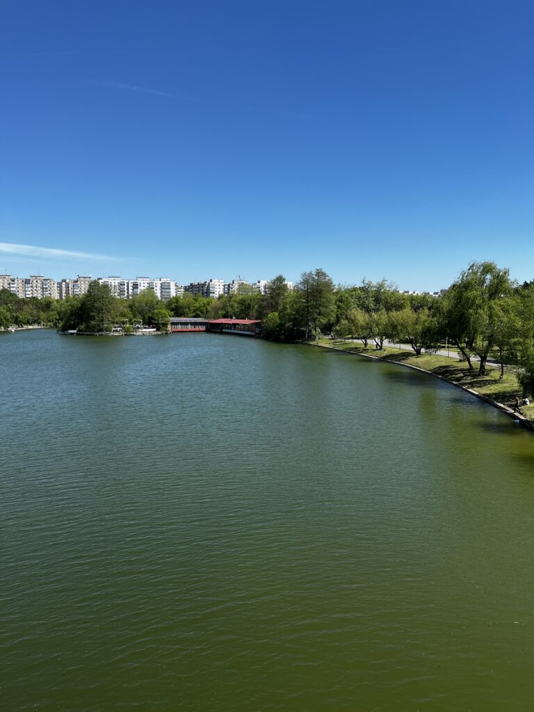 Wide view of Lake Tineretului with apartment blocks in the background, Bucharest