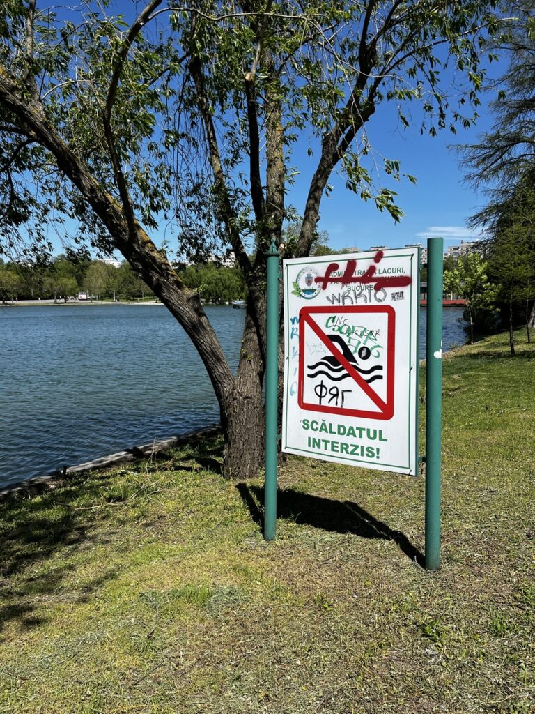 No swimming sign posted at the shore of Lake Tineretului, Bucharest