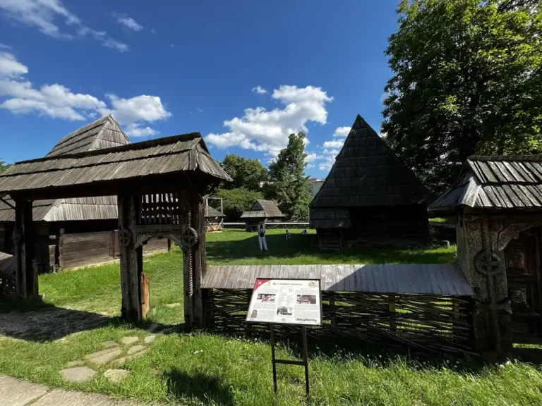 Wooden gate and courtyard among the traditional households at Muzeul Satului.