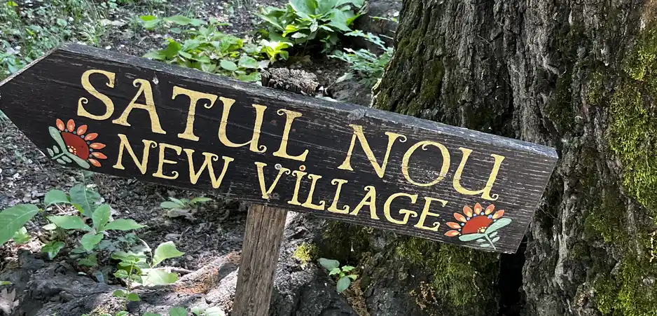 The wooden Satul Nou (New Village) sign at the museum.