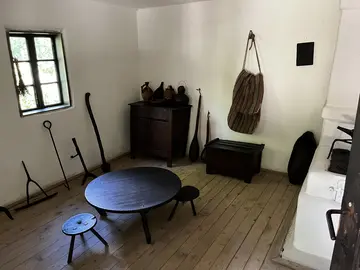 Cooking equipment and household objects inside a traditional home.