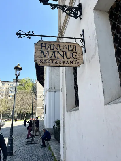 Hanu’ lui Manuc restaurant sign hanging above Strada Franceză.