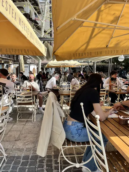 Outdoor tables and diners in Hanu’ lui Manuc’s central courtyard.