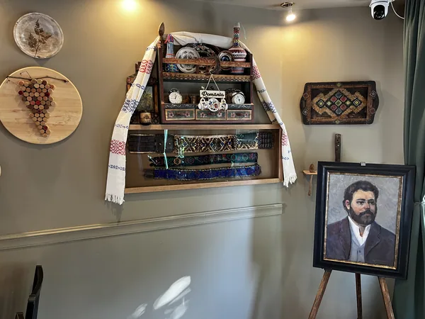 Cabinet displaying ceramics, textiles and old household objects at Restaurant Ceaun.