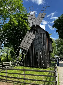 Wooden windmill rising above the museum paths.