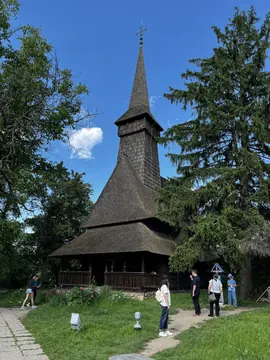 Tall wooden church tower above the surrounding trees.
