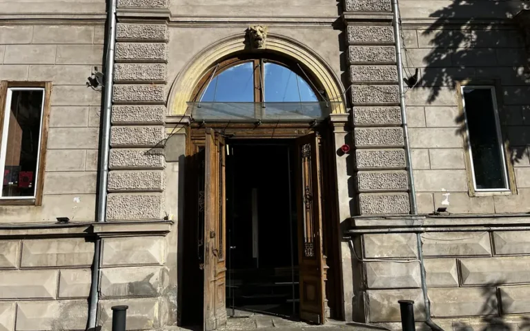 Arched entrance and historic façade of Cărturești Verona in Bucharest.