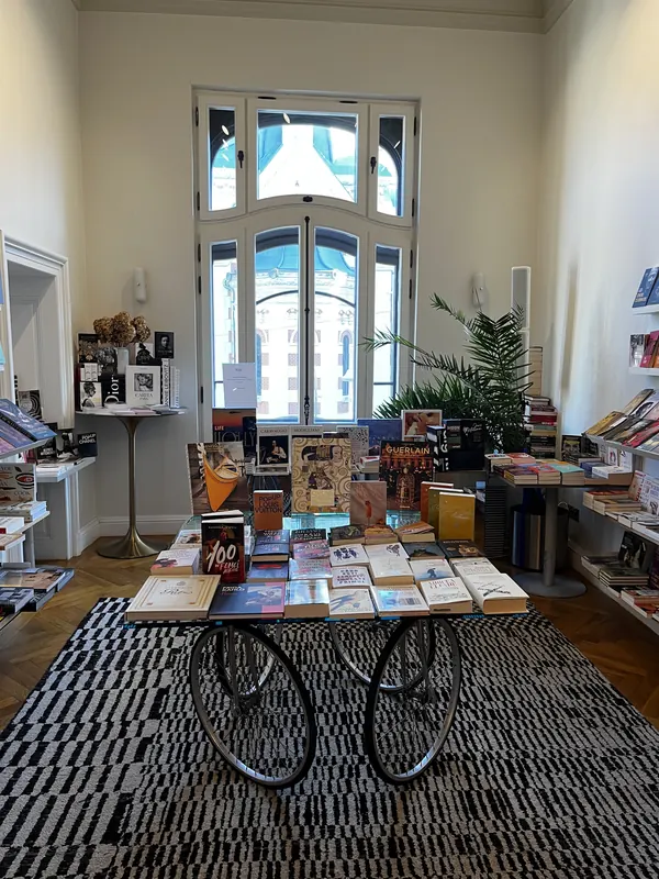 Books displayed on a bicycle-supported table inside Casa Mița Biciclista
