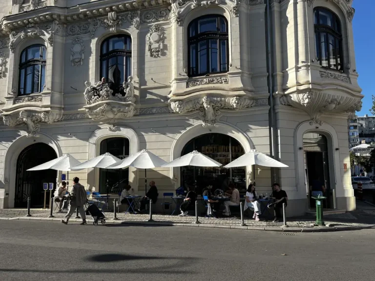Sculpted balconies and arched ground-floor windows at Casa Mița Biciclista