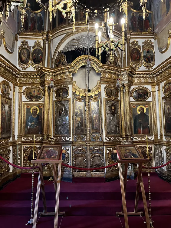 Close view of painted icons and gold decoration on the church iconostasis.