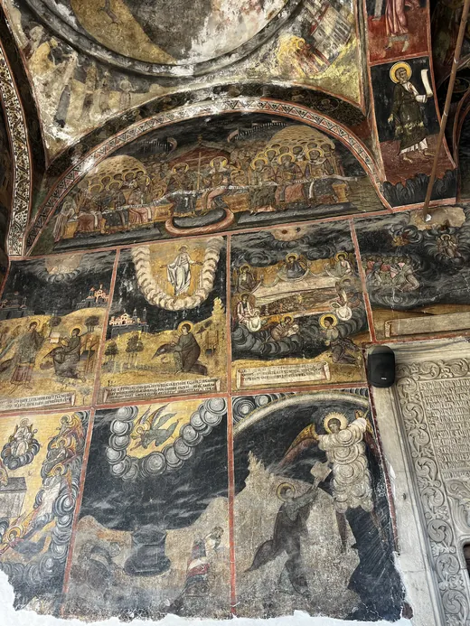 Frescoes across the vaulted porch and entrance wall inside Kretzulescu Church.