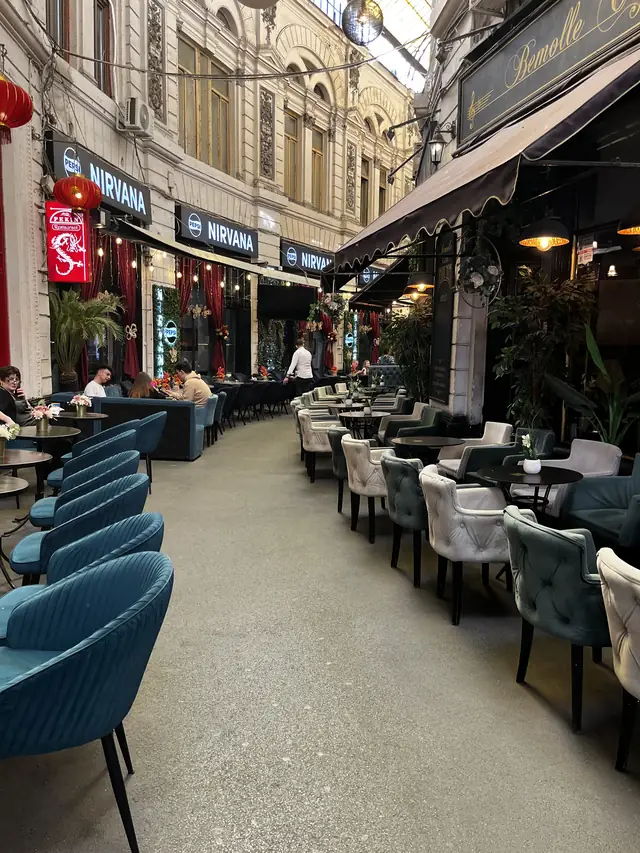 Nirvana awnings and Pekin sign beside café seating in Macca–Villacrosse Passage.