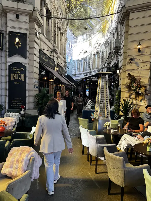 Café terraces and upper façades along a covered branch of Macca–Villacrosse Passage.