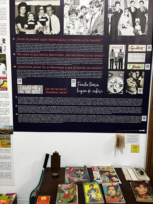 Femeia magazines and family-policy photographs beneath a multilingual museum panel.
