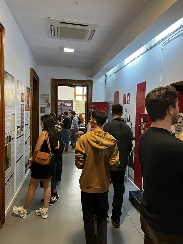 Visitors reading historical information panels in the museum corridor.