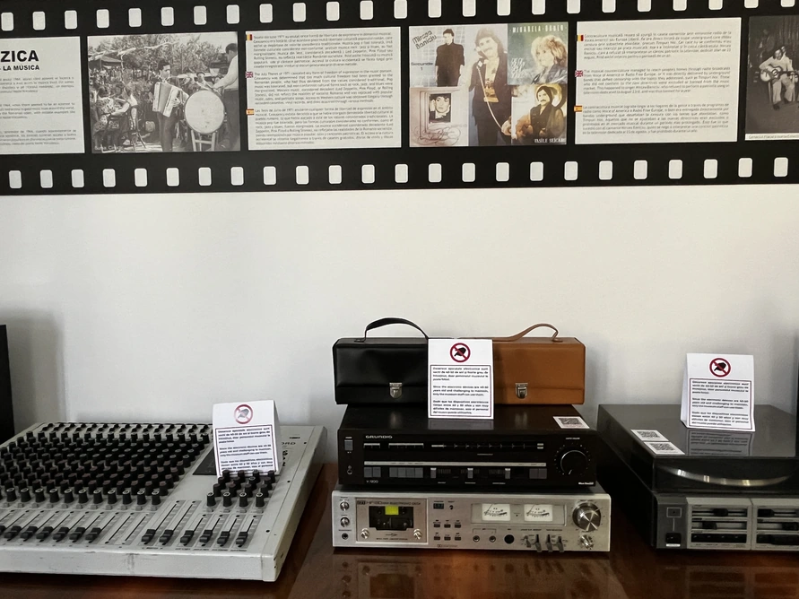 Vintage mixer, cassette deck and turntable with notices asking visitors not to touch the equipment.