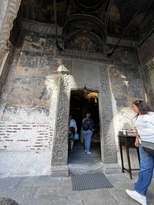 Carved stone doorway and inscriptions beneath the porch at Stavropoleos Church.