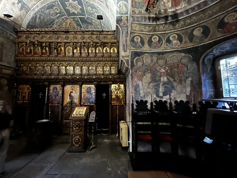 Iconostasis, painted walls and icon stand inside Stavropoleos Church.