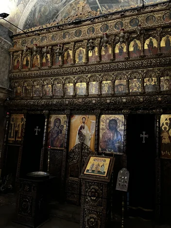 Rows of painted icons on the wooden iconostasis at Stavropoleos Church.