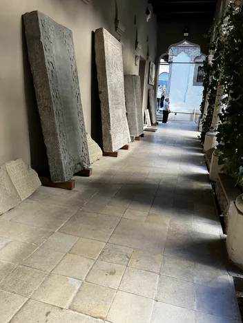 Stone slabs along a covered corridor at Stavropoleos Monastery.